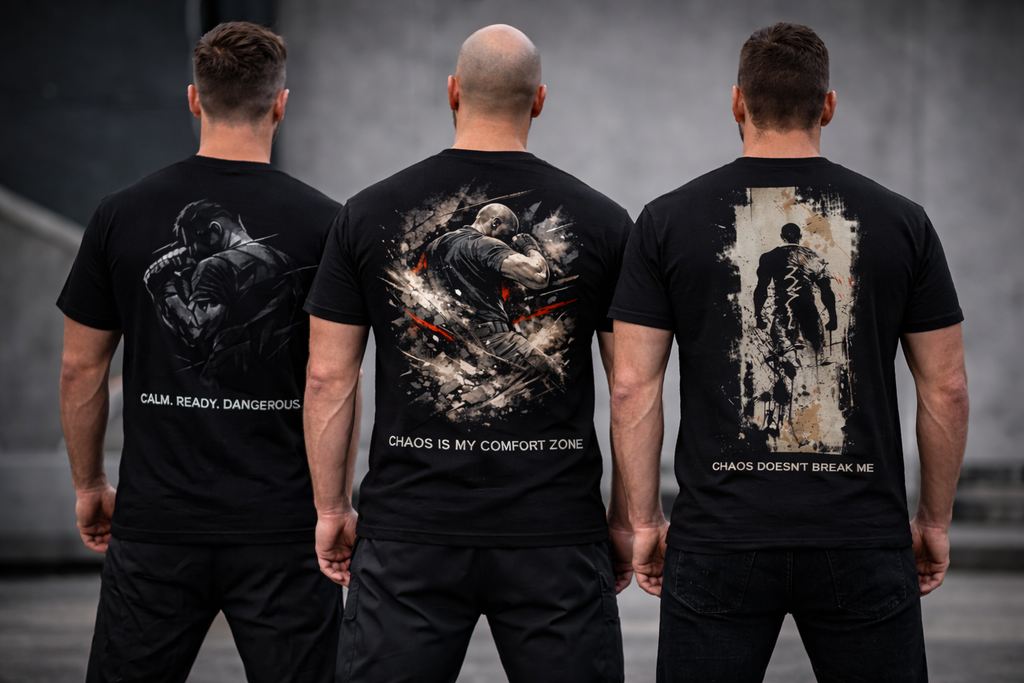 Three men wearing black t-shirts with Krav Maga graphic designs on the back, standing side by side.