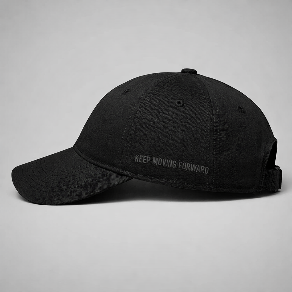 Black baseball cap with black tonal writing on a white background